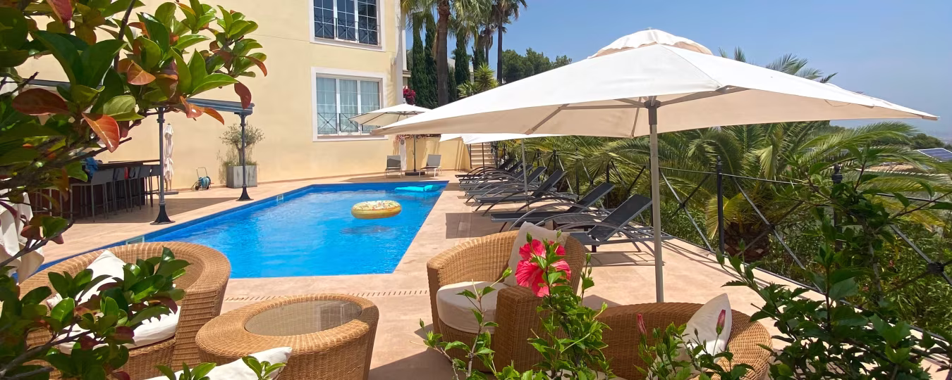 Buitenzwembad met helder blauw water en ligstoelen in vakantiehuis Mallorca Son Vida